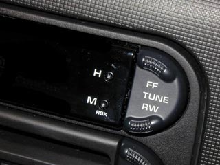 IMAGE: A panel at the top of a car radio, with tiny holes used to set the car clock.